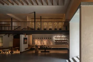 Open hotel lobby with white walls, multiple chairs, and dining tables, providing a comfortable and inviting atmosphere