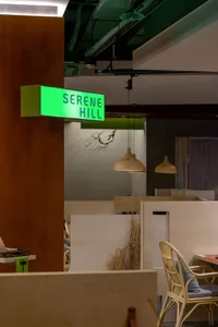 A modern office space with an open layout, featuring several chairs and a dining table, designed for collaboration and productivity