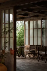 A warm and inviting dining space with wooden chairs and tables, creating a cozy atmosphere for gatherings and meals