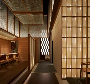 Warm and inviting restaurant interior with wooden floors and walls, featuring chairs and dining tables