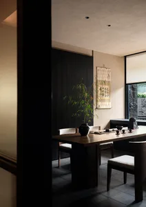 Elegant dining space with a wooden table, chairs, and potted plants, featuring traditional Asian design elements