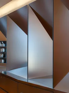 A kitchen with glass doors, a countertop, and a sink, flooded with natural light