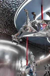 A room with various metal animal sculptures on the walls, creating a creative and visually engaging atmosphere