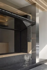 Interior view of a modern house with two glass windows and a door, featuring a minimalist design