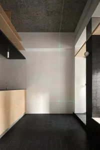 Empty modern kitchen with white walls and black countertops, minimalist and sleek design