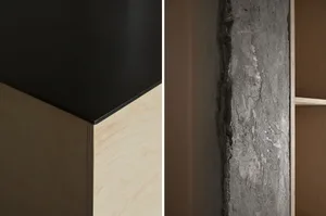 Two kitchen countertops with modern designs, one with a wood grain finish and the other with a grey concrete surface, in a dimly lit setting