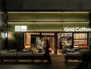 A restaurant with multiple tables and chairs, creating a warm and inviting atmosphere for dining and socializing