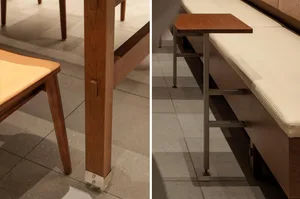 A modern dining space with a wooden table and metal table, bench seating, a couch, and a chair, in a cozy atmosphere
