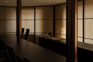 Empty dining area with a wooden table and chairs, creating a calm and inviting atmosphere