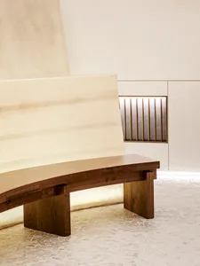 Empty room with a wooden bench in the center, creating a calm and quiet atmosphere