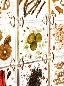 A colorful arrangement of fruits and vegetables in a glass display case, showcasing a variety of fresh produce