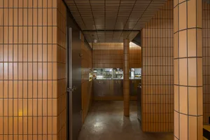A warm and inviting kitchen with a tile wall, a brown brick wall, and various kitchen items on display