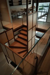 A photo of a well-lit stairwell with wooden stairs, creating a bright and inviting atmosphere