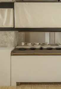 A clean and organized kitchen counter with various bowls of different sizes placed on its surface