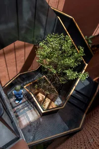 A wooden staircase in a building with natural light from windows, creating an inviting and comfortable atmosphere