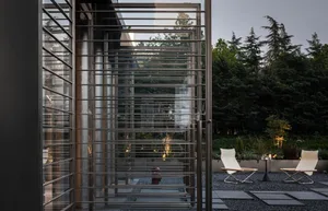 A patio area with a dining table and two chairs, a fire hydrant in the center of the scene