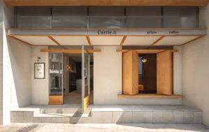 Inviting restaurant interior with wooden exterior, dining area, chairs, and a potted plant near the entrance
