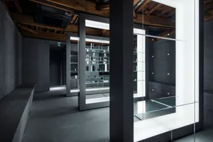 Empty bathroom with a large mirror on one wall, reflecting the surrounding area and creating a sense of depth