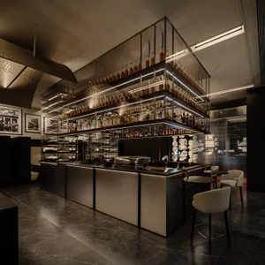 A sophisticated bar area with a long wooden counter and a display of liquor bottles, surrounded by comfortable seating and warm lighting