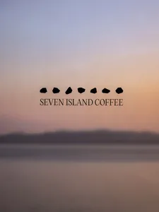 A serene sunset scene over a body of water with seven small islands in the distance, set against a cloudy sky