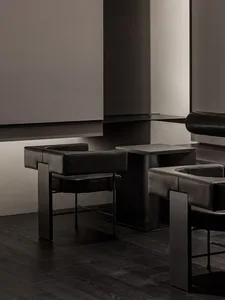 Modern showroom with black leather chairs, dining tables, and warm lighting creating a stylish atmosphere