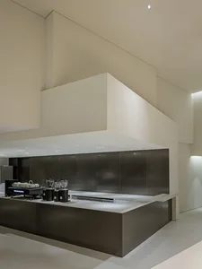 Industrial kitchen with white walls and cabinets, featuring two sinks, various kitchen items, and a clean and organized atmosphere