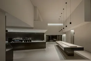 Spacious modern interior with a long countertop, ceiling lights, and a clean atmosphere