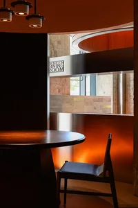 A warm and inviting dining area with a wooden table and chairs, perfect for socializing and enjoying meals together