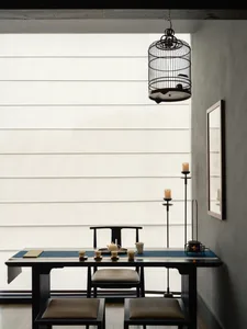 A modern office space with a desk and dining table, featuring a chair, cups, and bowls, with a neutral background