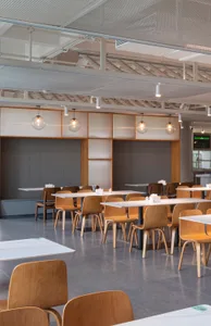 Empty restaurant with wooden tables and chairs, clean and inviting atmosphere with warm and cozy feel