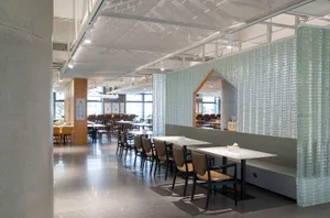 A casual restaurant with multiple dining tables and chairs, creating an inviting and comfortable atmosphere for guests
