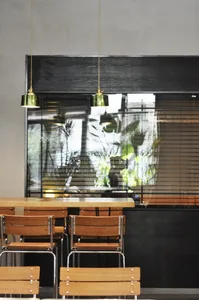 Modern restaurant interior with wooden tables and chairs, creating a warm and inviting atmosphere