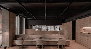 Empty modern restaurant interior with wooden walls and flooring, featuring dining tables and chairs