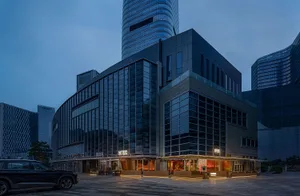 A modern building with a glass facade, multiple windows, and a contemporary urban atmosphere