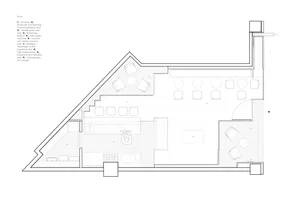 Empty office space with a large triangle shape on the floor, simple design, and scattered chairs
