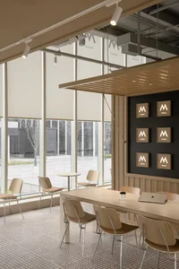 A modern showroom with open seating areas, TV screens, and ample space for product displays