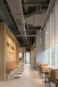 Inviting restaurant interior with wooden floors, white walls, and multiple chairs for guests