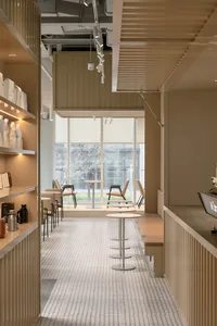 A modern showroom with various seating areas, chairs, and dining tables, designed to showcase furniture and other elements