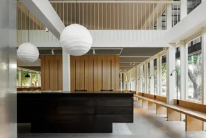 Inviting dining space with multiple tables, round lamps, and comfortable seating