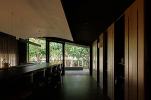 Cozy restaurant with black and white theme, modern seating, and natural light from a large window