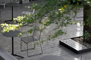 A patio area with metal chairs arranged around a dining table, creating a relaxed and inviting atmosphere for outdoor dining