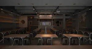 Dimly lit restaurant with metal tables and chairs, creating a cozy atmosphere