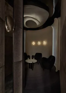 A cozy dining area with a wooden table and chairs, wine glasses, and a warm atmosphere