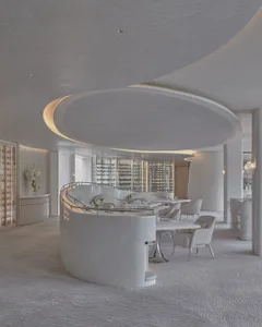 Elegant restaurant interior with a circular bar featuring a curved countertop, wine glasses, and bottles, creating a sophisticated and inviting atmosphere