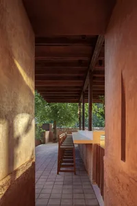 Stone patio with a dining table and chairs, surrounded by a comfortable outdoor seating area