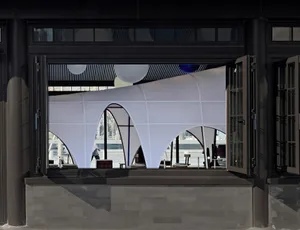 A well-lit dining area with multiple chairs and couches, suggesting a restaurant or social gathering space