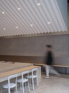 A casual restaurant dining area with multiple chairs and small tables arranged throughout the space, creating a comfortable atmosphere for patrons