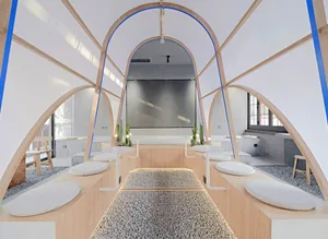 Calm and inviting spa space with wooden walls and floors, featuring couches and chairs for relaxation