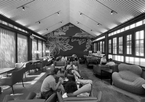 A cozy restaurant with multiple chairs and dining tables, couches, and people enjoying their time together in a warm and inviting atmosphere