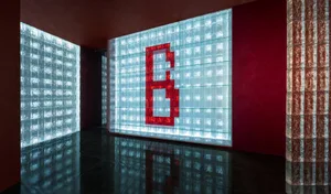 A glass case displays a red letter B in a creative and artistic way